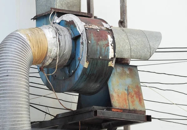 Old smokestack machine for smoke out from kitchen. Chimney on roof.