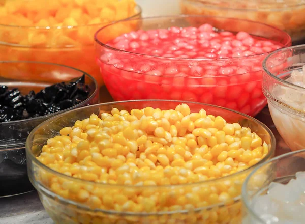 Sweet tropical corn with syrup in glass bowl. Thai dessert (ruam mit)