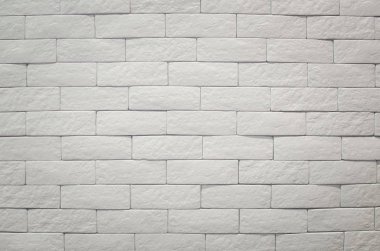 Beyaz tuğlalı bir duvar. Temiz beton şebeke beyaz tuğlalar dizayn yığını. İç arkaplan.