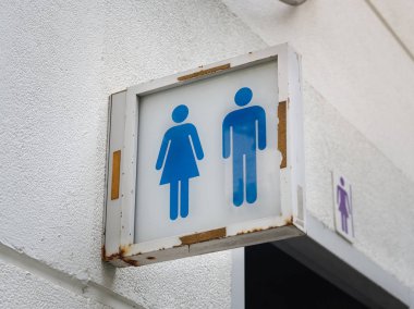 Male and female toilet sign on the toilets in the public park.