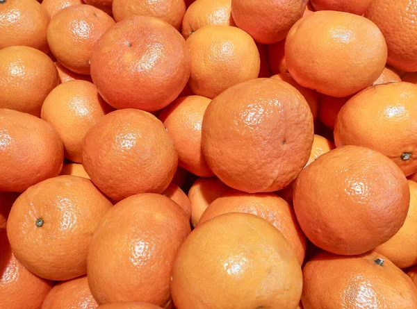Fresh mandarin oranges ready for sale. Tropical orange fruits on farm market.