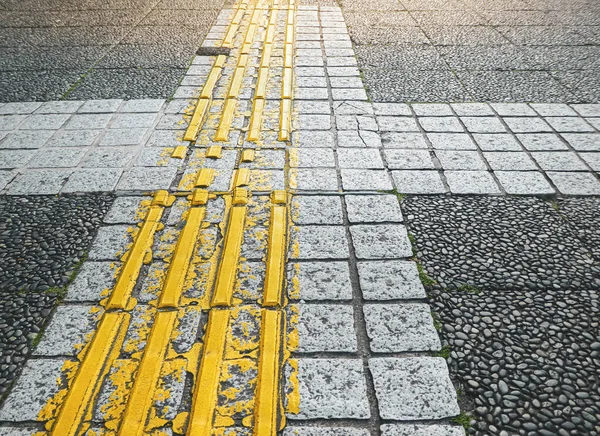 Japanese Sidewalk Interfaces for the blind, Sidewalk Interfaces in between train stations in Japan.