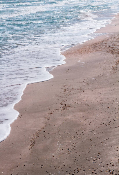 Soft sea waves on the sandy beach