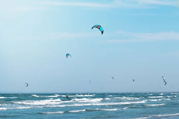 Kitesurfing in the waves in Sea of Azov on blue sky background — Stock Image Kitesurfing Waves Sea Azov Blue Sky Background Stock Photo