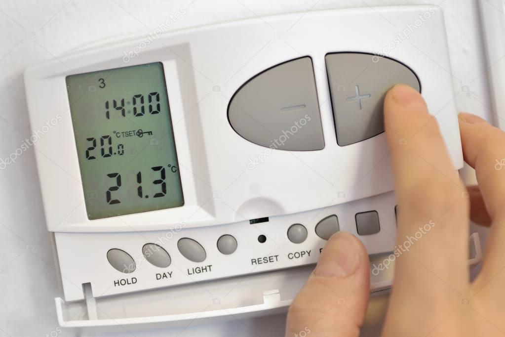 pressing button on digital thermostat