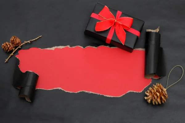 Black Torn Paper And A Gift — Stock Photo, Image