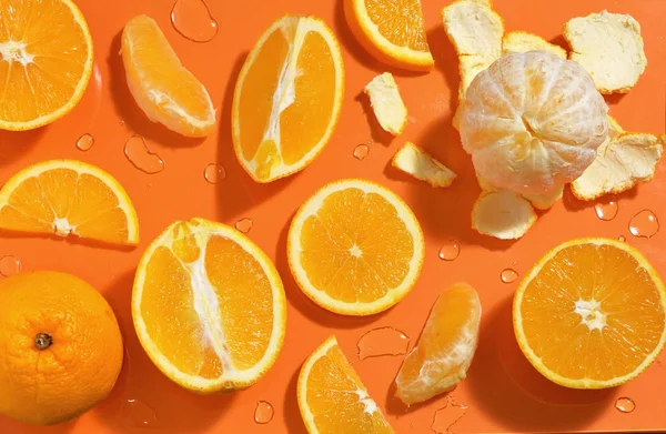 Slices of Orange Citrus Fruits On Orange Background — ストック写真