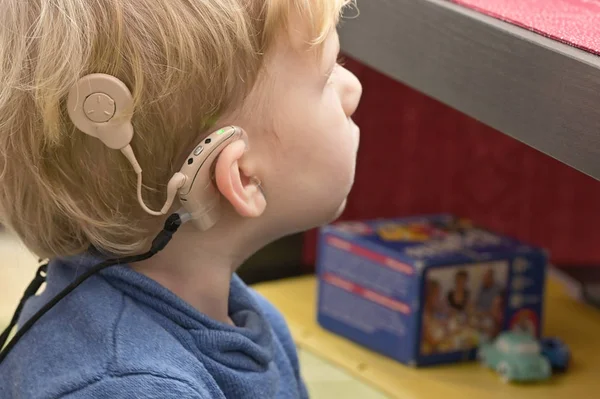 Pojke med hörapparat och Cochlear implantat Royaltyfria Stockfoton