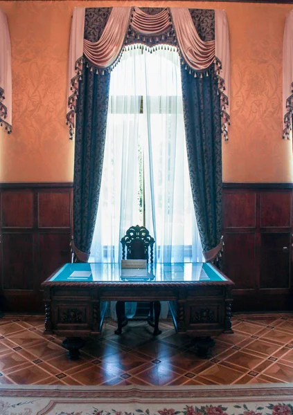 An antique table by the window. — Stock Photo, Image