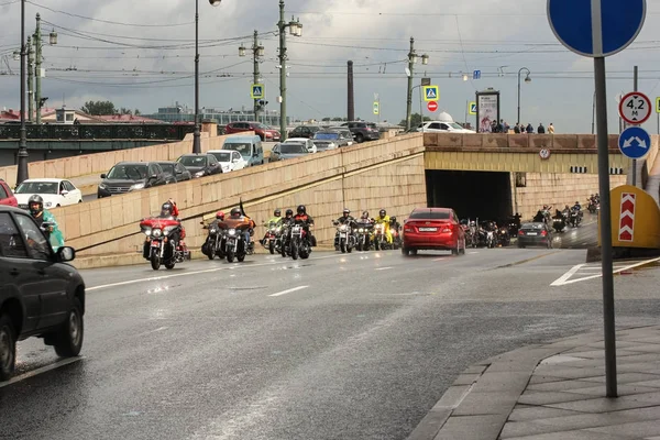 Una columna de motocicletas pasa por debajo del puente . — Foto de Stock