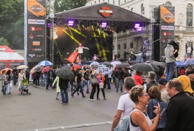 İnsanlar şemsiye altında aşamada.