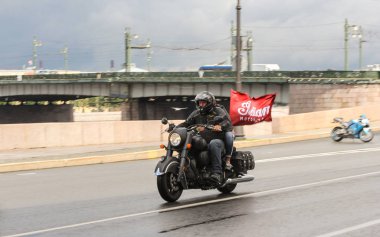 Bir motosiklet bir kırmızı bayrak ile insanlar.