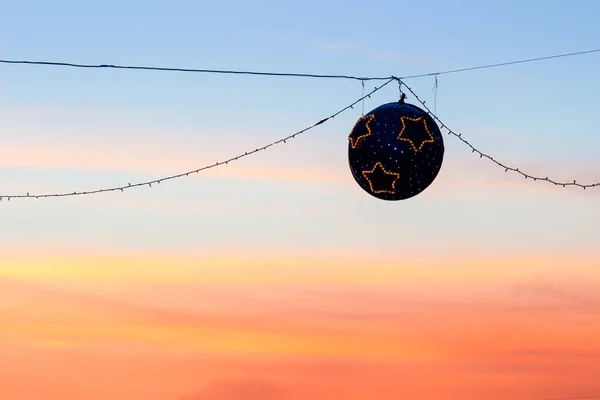 Christmas street lights at sunset — Stock Photo, Image