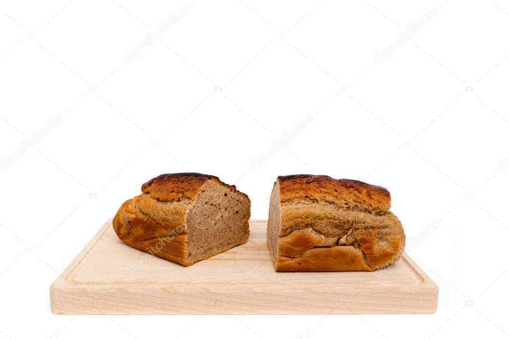 A homemade plumcake standing on a wooden board with a white background