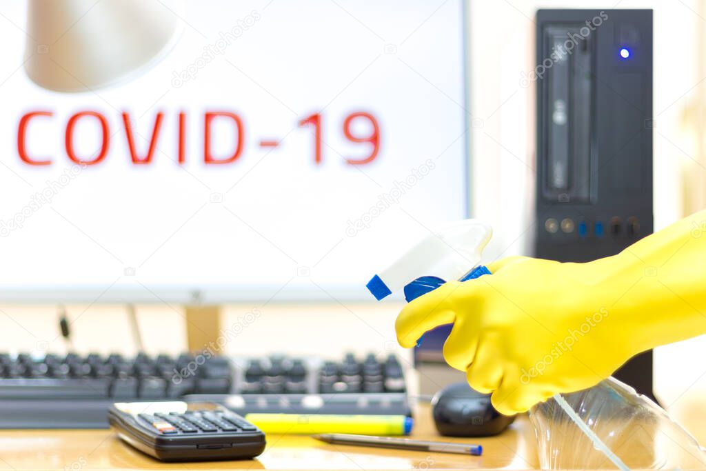 Disinfecting of an office with spray and glove to prevent COVID-19 disease