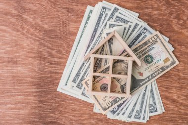 ahşap ev modeli üzerinde dolar para