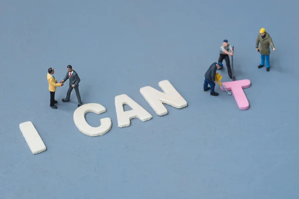 Technician removing the letter t of the word I can 't — стоковое фото