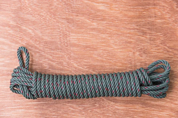 Green rope on wood background — Stock Photo, Image