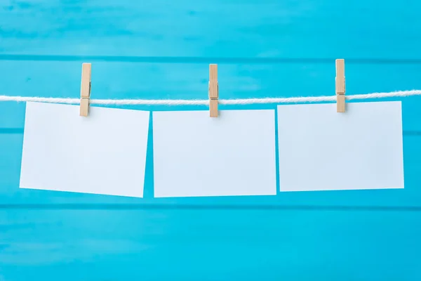 Empty three white photo frames hanging with clothespins — Stock Photo, Image