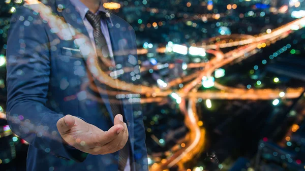 Double exposure of business man with night city background — ストック写真