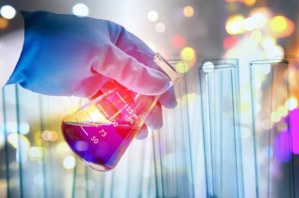 Double exposure of scientist hand holding laboratory test tube — Stock Photo, Image