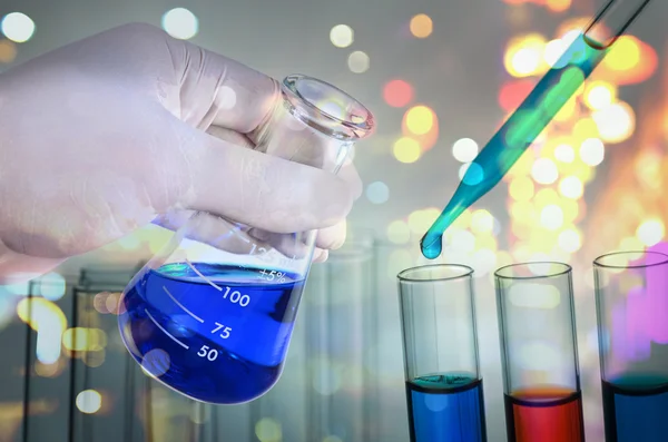 Double exposure of scientist hand holding laboratory test tube — Stock Photo, Image