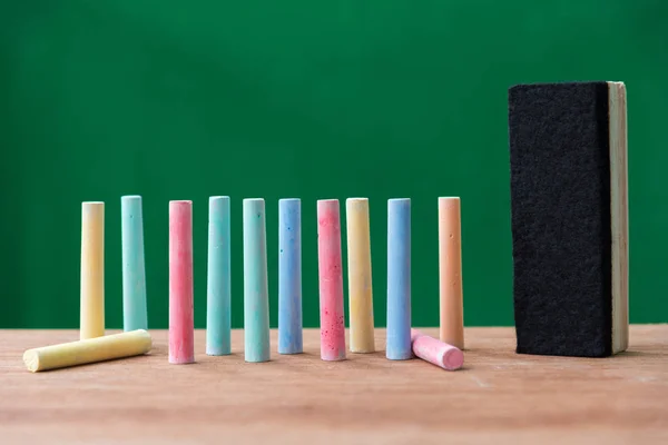 Chalks in a variety of colors and brush on table — Stock Photo, Image