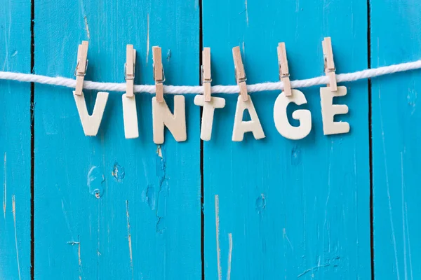 Wood text VINTAGE hanging with clothespins — Stock Photo, Image