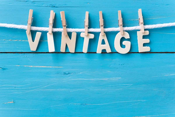 Wood text VINTAGE hanging with clothespins — Stock Photo, Image