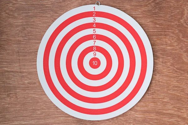 Red dartboard on wood background — Stock Photo, Image