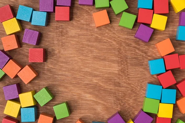 colorful wood cube building blocks on wood background