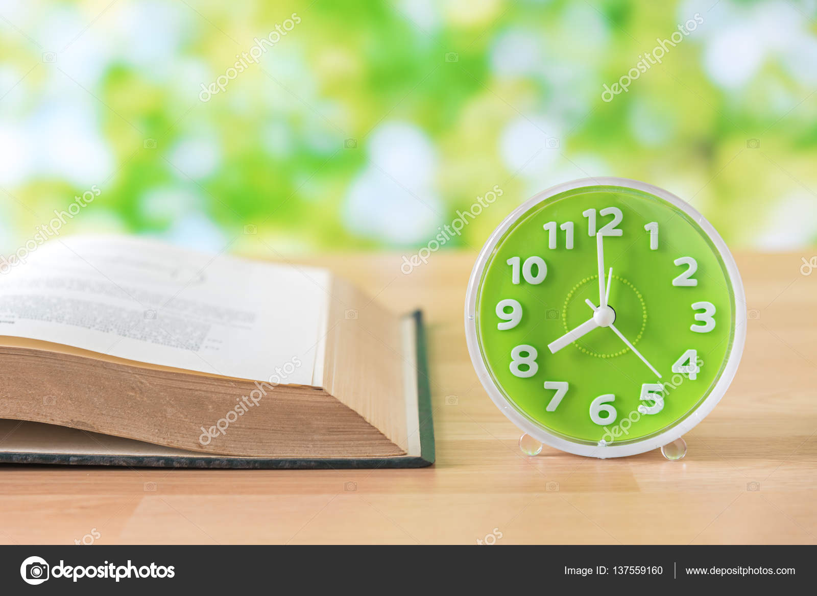 Green Clock And Open Book On Wooden Table Stock Photo Kwanchaidp Green Clock And Open Book On Wooden Table Stock Photo