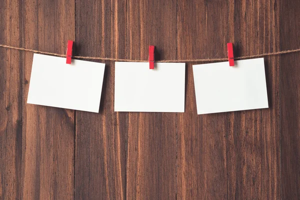 Rows of empty photo frames hanging with clothespins on wooden ba — Stock Photo, Image