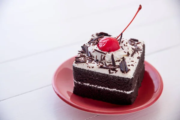 black forest cake with fresh cream on white table