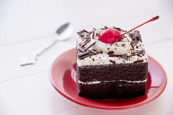 Black forest cake with fresh cream on white table Stock Picture