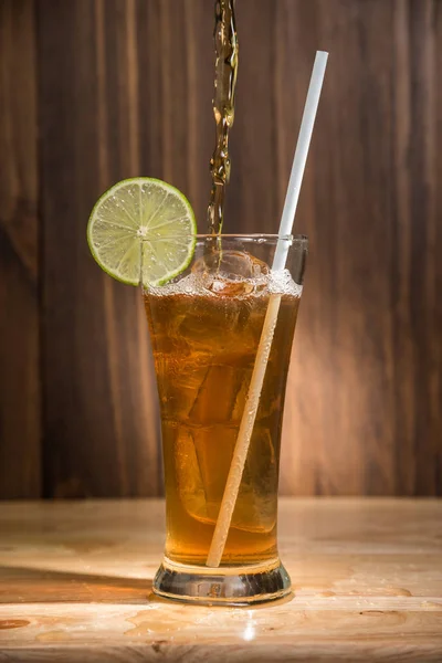 Стакан чая со льдом на деревянном столе — стоковое фото