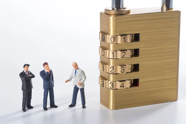 Business miniature people try to unlock security lock key — Stock Photo, Image
