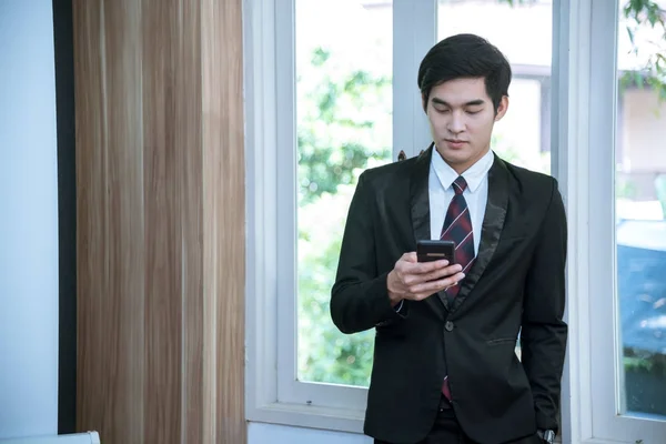 business man checking smartphone