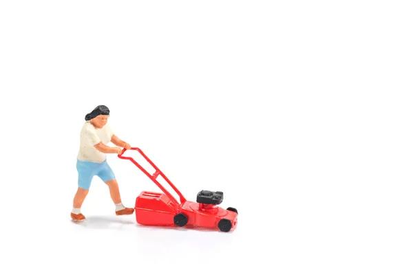 Miniature people figure holding mower isolated on white backgrou — Stock Photo, Image