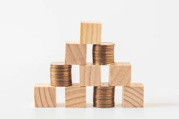 Stack of wood cube building blocks and money coins Stock Photo