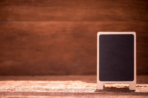 blank black menu board on wooden table