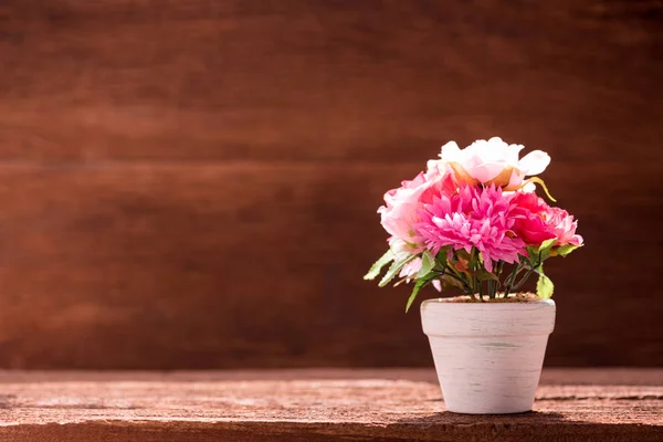 Vit konstgjord blomkruka på träbord — Stockfoto