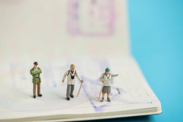 Miniature traveler on passport book — Stock Photo, Image