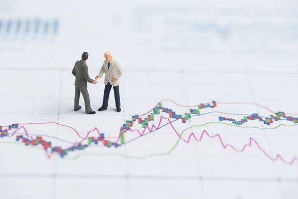 Business miniature people on business graph — Stock Photo, Image