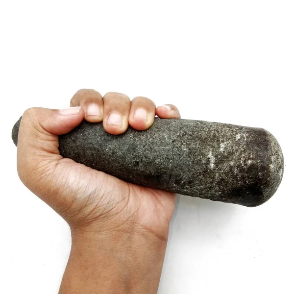 Hand holding oude granieten stamper — Stockfoto