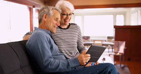 Senior Couple Sitting Couch Watching Videos Tablet — Stock Photo, Image