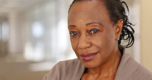 Close-up of a smiling elderly African American woman at work