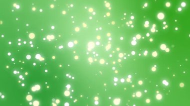 Yeşil bir arka planda hareketli ışıltılı parçacıklar