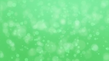 Balon parçacıklarının yüzen ile büyülü ışık yeşil parlayan bokeh arka plan.