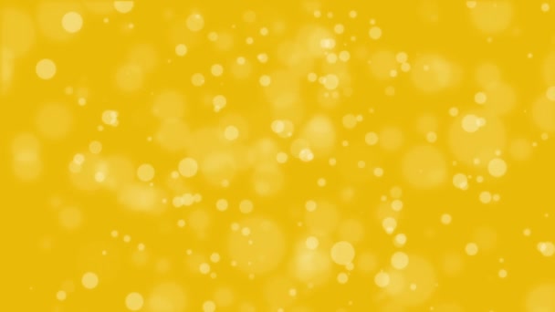 Lumineux fond bokeh jaune doré animé avec des particules de lumière brillantes .